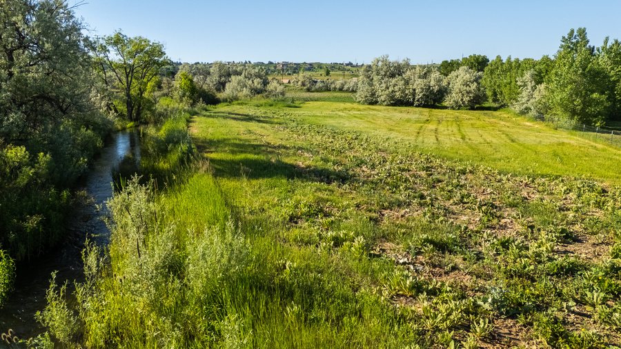 Pasture, creek and Flatirons views on the 7035 South Boulder Road equestrian property in Boulder County, Colorado